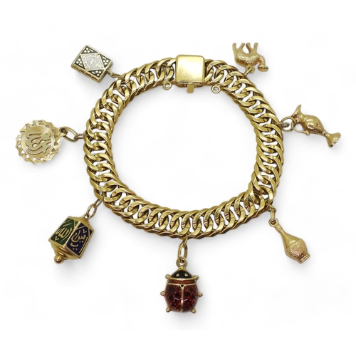 An Arabic gold double curb chain bracelet, with Arabic gold marks to every link and the clasp, with seven attached charms, three in 18k gold , three with Arabic marks and one in yellow metal, weight all together 75.6gms