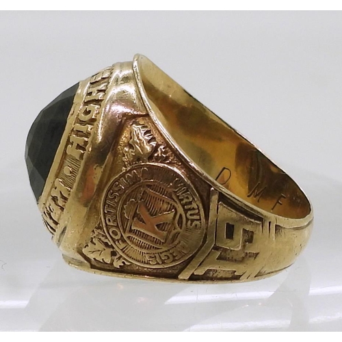 809 - A 10k gold Metal Arts Brand American College ring, Kensington High School 1965, set with a green gla... 