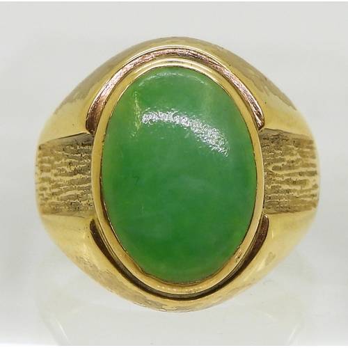 825 - A bright yellow metal ring stamped 18k, and set with a Chinese green hardstone of approx 16mm x 11mm... 