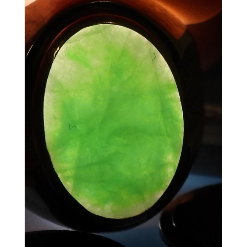 825 - A bright yellow metal ring stamped 18k, and set with a Chinese green hardstone of approx 16mm x 11mm... 