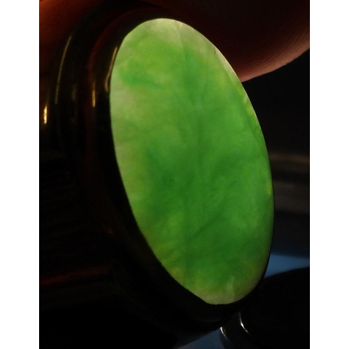 825 - A bright yellow metal ring stamped 18k, and set with a Chinese green hardstone of approx 16mm x 11mm... 