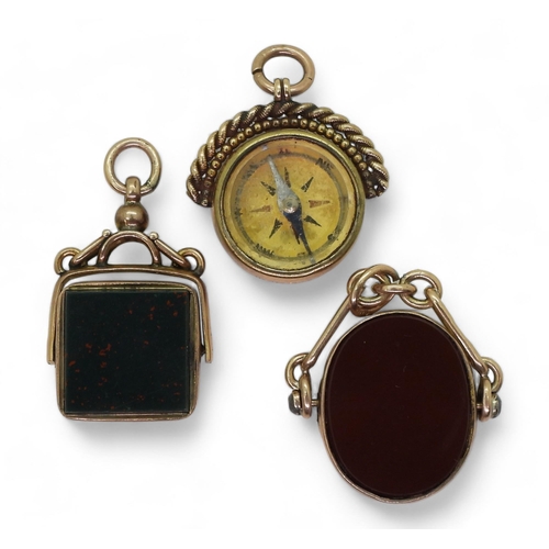 832 - Three 9ct gold carnelian / bloodstone fob seals one with a compass, weigh together 23.7gms 