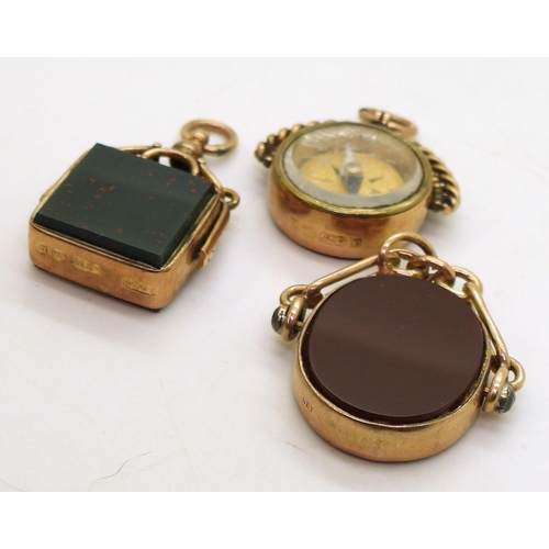 832 - Three 9ct gold carnelian / bloodstone fob seals one with a compass, weigh together 23.7gms 