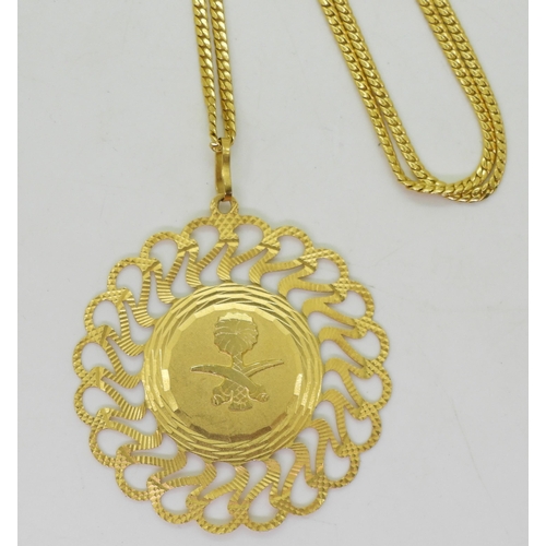 833 - An Italian made 21k gold pendant with the Emblem of Saudi Arabia, weight 13.2gms together with a bri... 