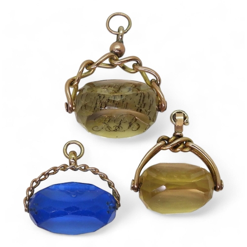 837 - Three swivel fobs, an intaglio carved monogrammed citrine example in 9ct mount, a yellow glass examp... 