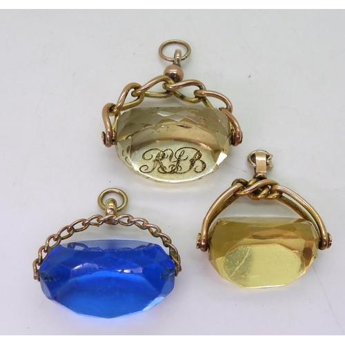 837 - Three swivel fobs, an intaglio carved monogrammed citrine example in 9ct mount, a yellow glass examp... 