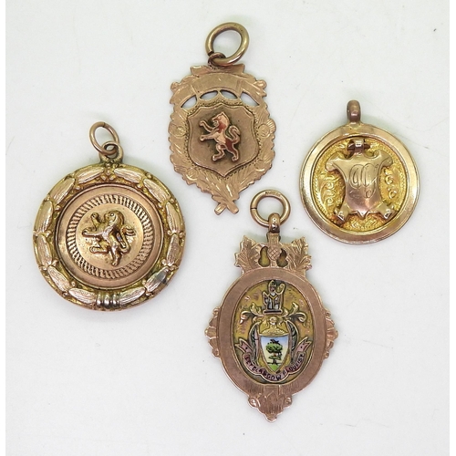 838 - Two 9ct gold enamelled detail medallions, a 9ct round medallion with shield and a yellow metal lion ... 