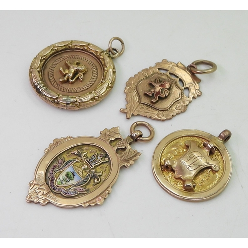 838 - Two 9ct gold enamelled detail medallions, a 9ct round medallion with shield and a yellow metal lion ... 