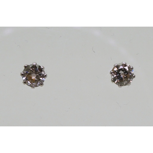 841 - A pair of 14k gold diamond stud earrings, set with estimated approx 0.30cts across the pair, weight ... 