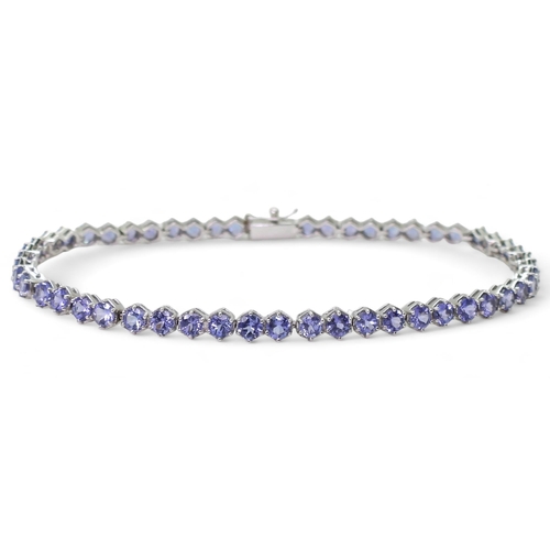 847 - A 18ct white gold tanzanite line bracelet, length 19.5cm, weight 9.5gms