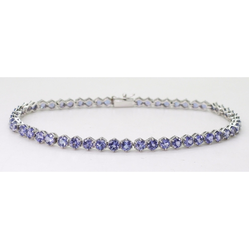 847 - A 18ct white gold tanzanite line bracelet, length 19.5cm, weight 9.5gms