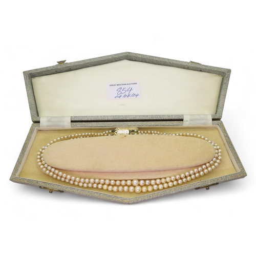 854 - A double string of cream pearls with a 9ct gold clasp, shortest strand approx 41cm