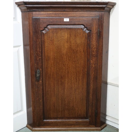 135 - A 19th century oak hanging corner cabinet with single panel door, 109cm high x 79cm wide 