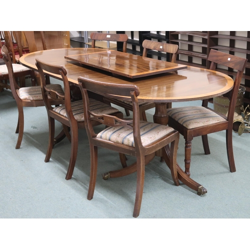 140 - A 20th century mahogany twin pedestal dining table and six chairs, table with two spare leaves on tr... 