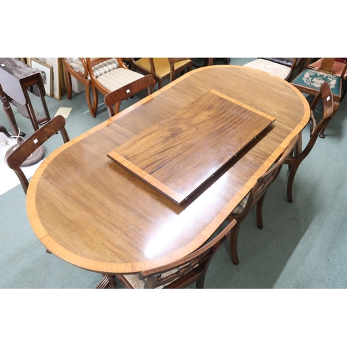 140 - A 20th century mahogany twin pedestal dining table and six chairs, table with two spare leaves on tr... 