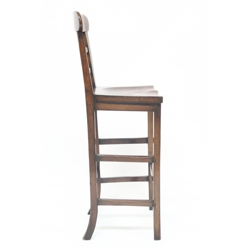 16 - A 20th century stained beech tall clerks stool with laddered back over shaped seat on square support... 