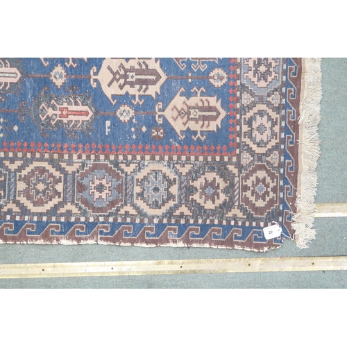 22 - A blue ground Turkish nomadic style rug with all over geometric patterned ground within multicoloure... 