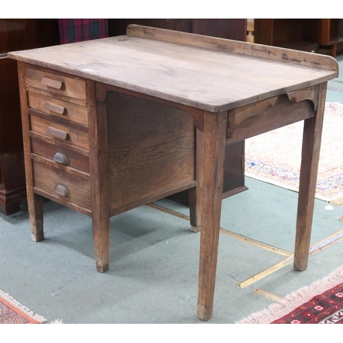 25 - An early 20th century oak G.R.V stamped writing desk with five graduating drawers on square tapering... 