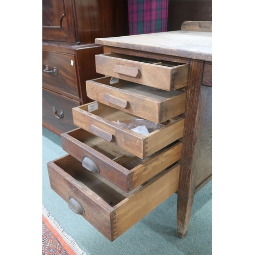 25 - An early 20th century oak G.R.V stamped writing desk with five graduating drawers on square tapering... 