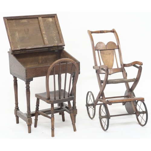 26 - A lot comprising an early 20th century oak Tri-Ang toy's child's writing desk, a beech child's railb... 