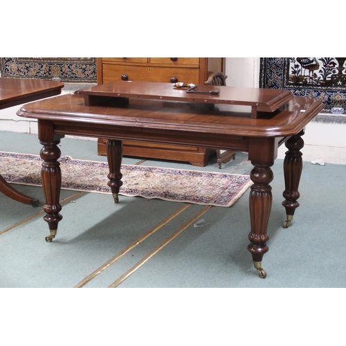 28 - A Victorian mahogany wind-out extending dining table with one spare leaf on turned supports terminat... 