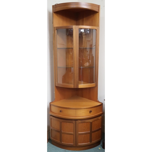 76 - A mid 20th century teak G Plan bow front corner cabinet with pair of bowed glazed doors over pair of... 