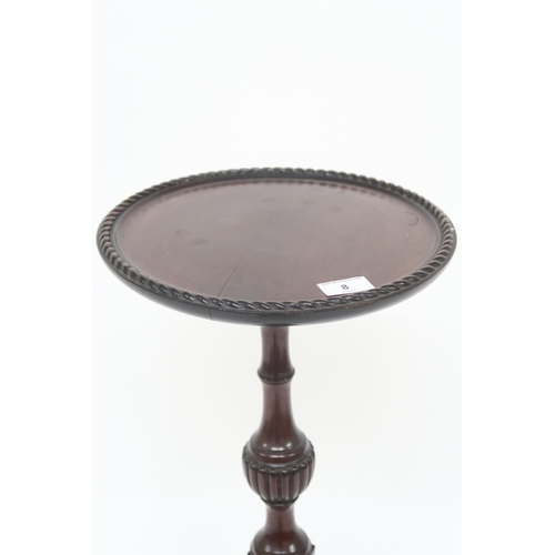 8 - A 20th century mahogany circular topped jardiniere stand with turned octagonal column support on tri... 