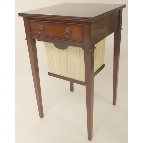 91 - A 20th century mahogany sewing work table with single drawer over slide out hamper on square taperin... 