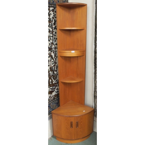 92 - A mid 20th century teak G Plan corner cabinet with three open shelves over pair of bowed cabinet doo... 