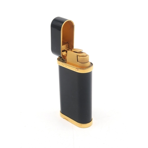 302 - A boxed Cartier cigarette lighter, no. 189022; together with a black bifold wallet stamped 