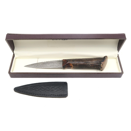 303A - A Sgian Dubh with Damascus steel blade and burnt antler handle, the blade measuring approx. 8.8cm in... 