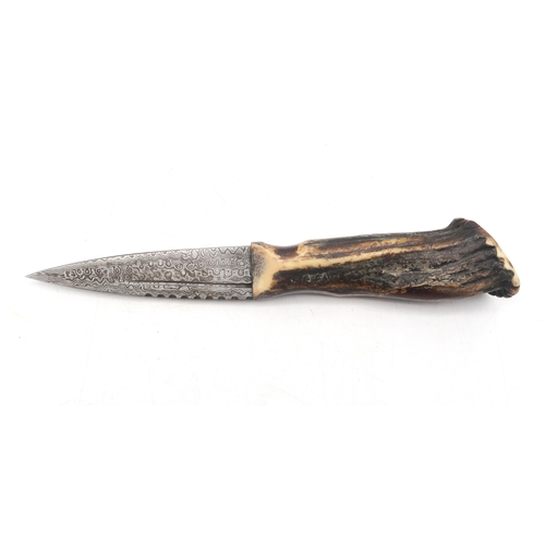 303A - A Sgian Dubh with Damascus steel blade and burnt antler handle, the blade measuring approx. 8.8cm in... 