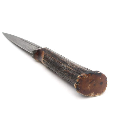 303A - A Sgian Dubh with Damascus steel blade and burnt antler handle, the blade measuring approx. 8.8cm in... 