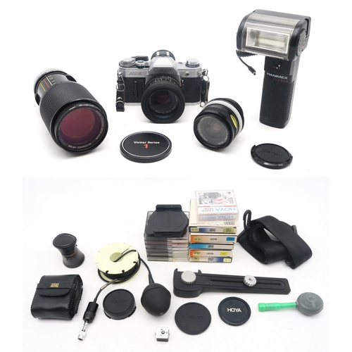 340 - A Canon AE1 35mm SLR camera, with original instruction manual fitted with a Canon FD 50mm 1:18 lens;... 