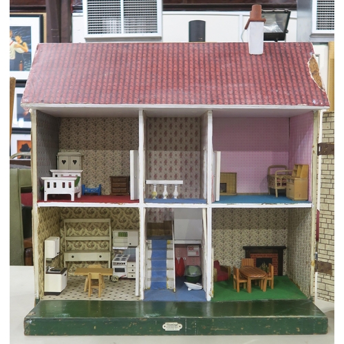 370 - A vintage Hamley's dolls' house, with porticoed front entrance, the hinged frontage opening to revea... 