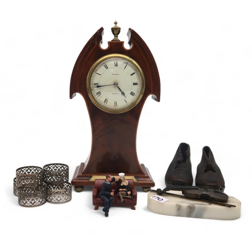 170 - A mixed lot including an Edwardian mantle clock, a pair of child's clogs, a bronze of a violin, napk... 