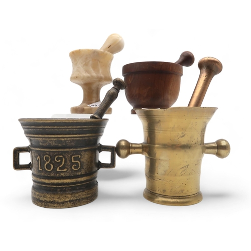 172 - A collection of pestle and mortars, including wood, onyx and bronze, the brass one dated 1825