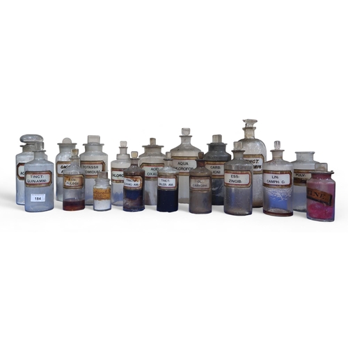 184 - A collection of 33 clear glass chemists jars, most with stoppers and white and gilt glass labels