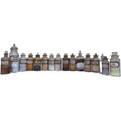 185 - A collection of 35 chemists bottles most with white and gilt glass labels, 13 with bubble stoppers