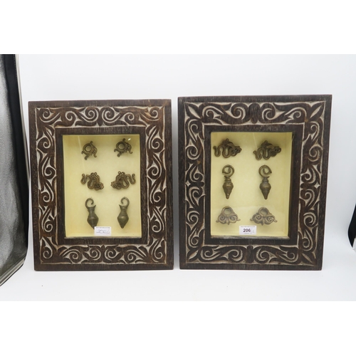 206 - Two framed groups of Borneo Dayak earrings or ear weights