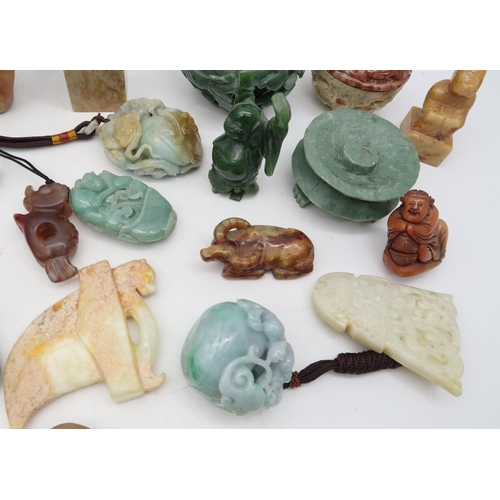 212 - A group of Japanese and other carved stone pendants, figures etc