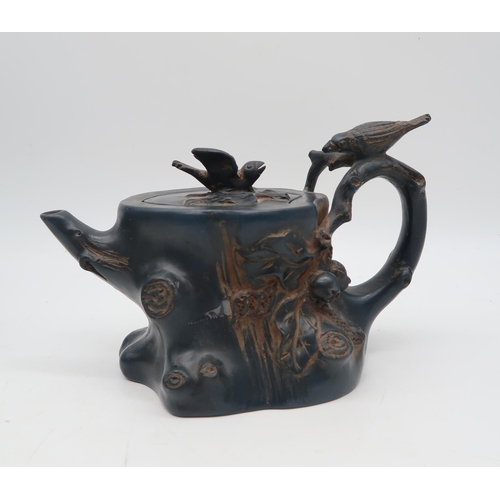 215 - A Japanese teapot in the form of a tree with birds, a glazed ceramic pot with fo dog finial, a stone... 