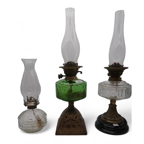 226 - Four assorted oil lamps together with a brass planter with vine decoration