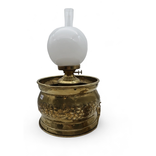 226 - Four assorted oil lamps together with a brass planter with vine decoration