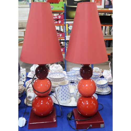 235 - A pair of French designer Louis Drimmer ceramic lamps and shades, in shades of red