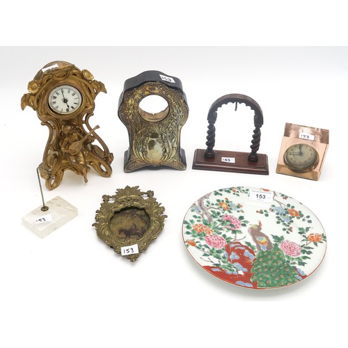 153 - A gilded Art Nouveau clock, a silvered front clock case, a rock crystal watch stand, a wooden exampl... 