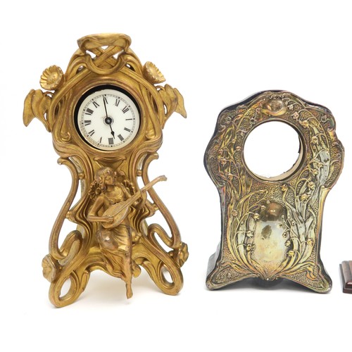 153 - A gilded Art Nouveau clock, a silvered front clock case, a rock crystal watch stand, a wooden exampl... 