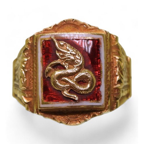 726 - A bright yellow metal ring, with enamelled panel of a serpent, stamped 90% with further Chinese char... 