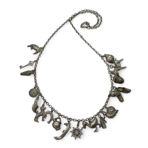 939 - A traditional Dutch silver charm necklace, with eighteen silver and white metal attached charms