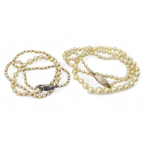 761 - Two strings of cultured pearls, one with a bi colour clasp, length 53cm